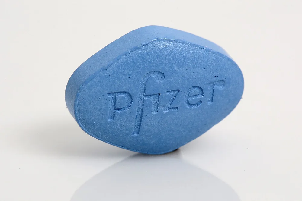 A brand-name Viagra tablet: the blue diamond-shaped 100 mg pill